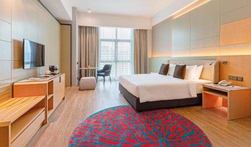 a hotel room with a bed and a television at Avante Hotel in Petaling Jaya