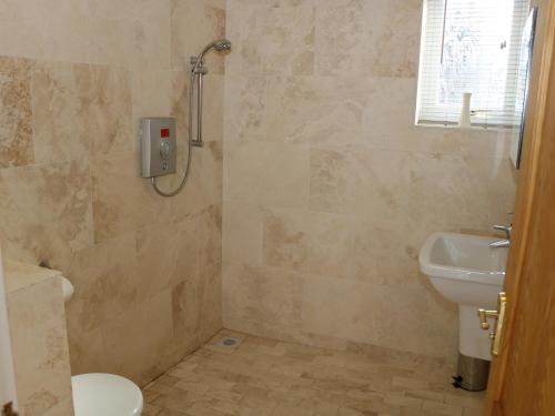 a bathroom with a shower and a toilet and a sink at Cherry Fields in Chesterfield