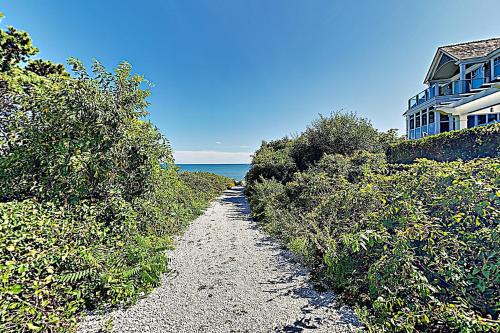 a path leading down to a beach with a house at Ocean Point Oasis in Mashpee