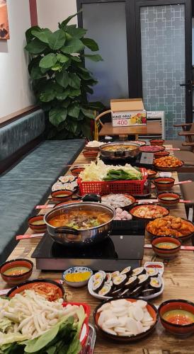 a table with many different types of food on it at BREAKING DAWN- TAEYANG Hotel Phú Quốc in Phu Quoc