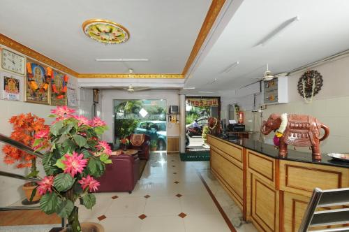 a lobby of a restaurant with a counter and flowers at Laila Palace in Salem