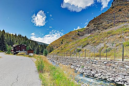 a road next to a river next to a mountain at Bellflower Trout House in Vail