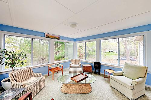 a living room with two chairs and a table at Headwater Hideaway in Harwich