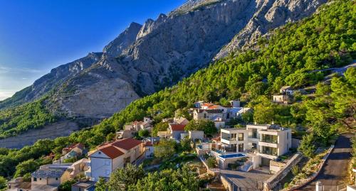 a village in the mountains with houses at Villa Bellevue Bast in Baška Voda