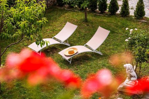 two lawn chairs and a table in the grass at Garmen Hills Guest Houses in Garmen