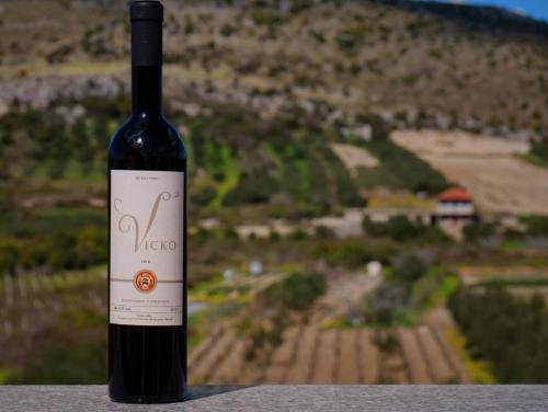 a bottle of wine sitting on top of a table at B&B Ave Maria in Vrpolje
