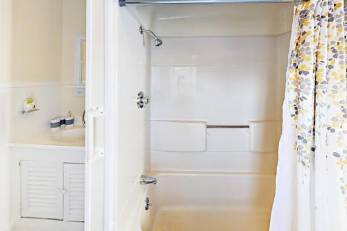 a bathroom with a tub and a shower curtain at Nickels-Sortwell House in Wiscasset