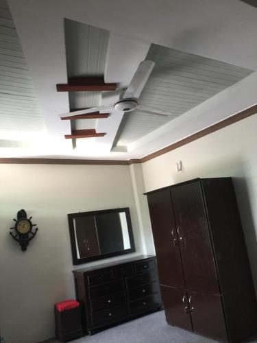 a living room with a ceiling fan and a tv at SWAT HiLL ViEW RESORT-only for families in Swat