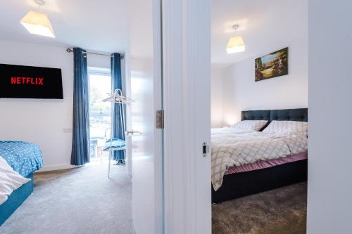 a bedroom with a bed and a view of a room at PIPI HOMES in Manchester