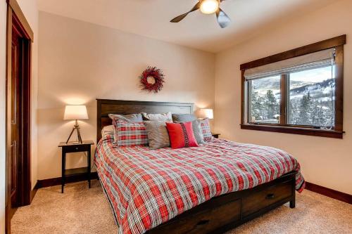 a bedroom with a bed and a window with a mountain at Blue River Condo Unit 203 in Silverthorne