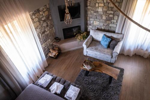 an overhead view of a living room with a stone wall at Mylaon Boutique Hotel & Spa in Vitina