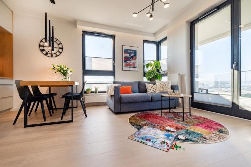 a living room with a couch and a table at Apartament Baltica Portova Gdynia in Gdynia