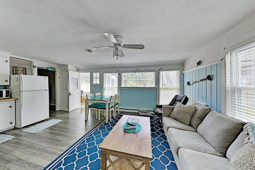 a living room with a couch and a table at Old Orchard Cottage in Old Orchard Beach