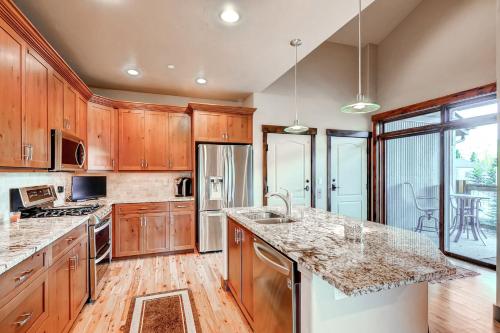 a kitchen with wooden cabinets and granite counter tops at Bears Den Condo Unit 1 in Frisco