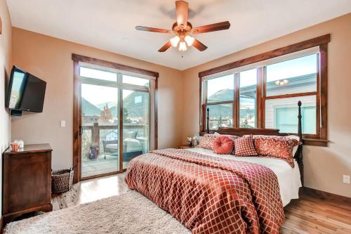 a bedroom with a bed and a ceiling fan at Bears Den Condo Unit 1 in Frisco