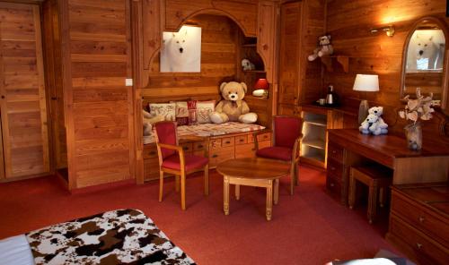 ein Zimmer mit einem Schreibtisch mit einem Teddybär darauf in der Unterkunft Hôtel Serre Palas in Les Deux Alpes