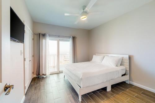 a bedroom with a white bed and a window at Las Joyas Bayview Home #202 in Port Isabel