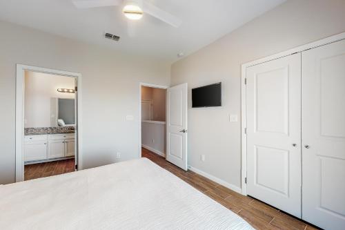 a white bedroom with a large bed and a mirror at Las Joyas Bayview Home #202 in Port Isabel