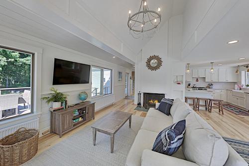 a living room with a couch and a tv at Newcastle Lake House in Newcastle