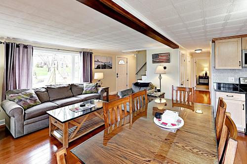a living room with a couch and a table at The Badger Den in Boothbay Harbor