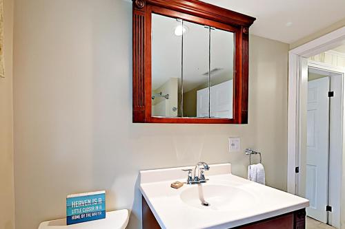 a bathroom with a sink and a mirror and a toilet at The Badger Den in Boothbay Harbor