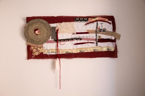 a small bed with a hat on a wall at S'Arena Lughente Deluxe Apartment in Alghero