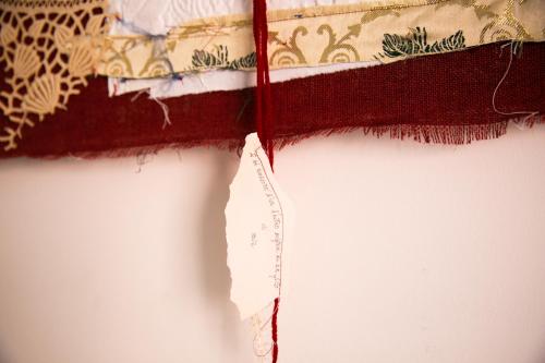 a red measuring tape sitting on top of a wall at S'Arena Lughente Deluxe Apartment in Alghero
