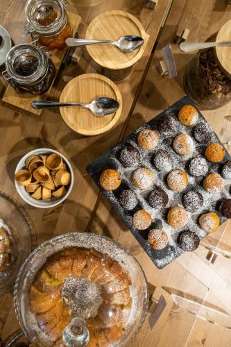 a table topped with trays of muffins and other foods at Hotel Master in Brescia