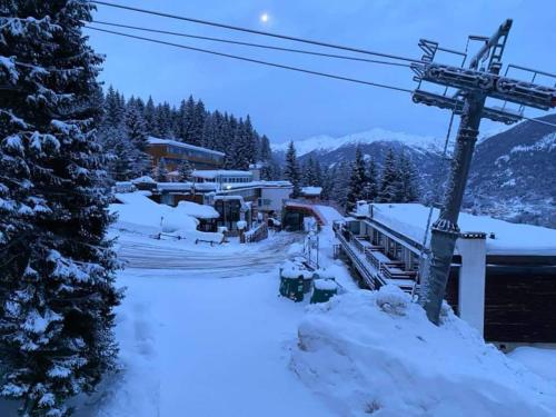 a ski resort covered in snow with a ski lift at La Tana del Gufetto in Marilleva