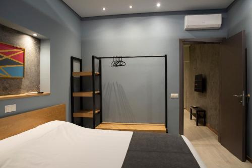 a bedroom with a bed and a door with a closet at City Twins in Thessaloniki