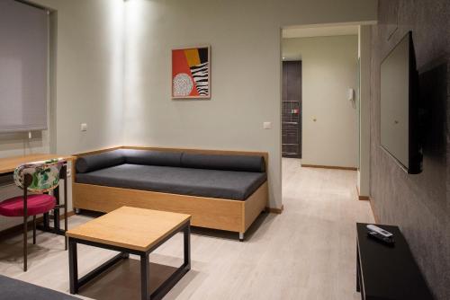 a living room with a bed and a table at City Twins in Thessaloniki
