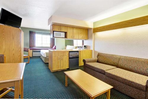 a hotel room with a couch and a bed at Microtel Inn & Suites by Wyndham Albuquerque West in Albuquerque