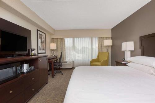 a hotel room with a bed and a flat screen tv at Wyndham Philadelphia-Historic District in Philadelphia