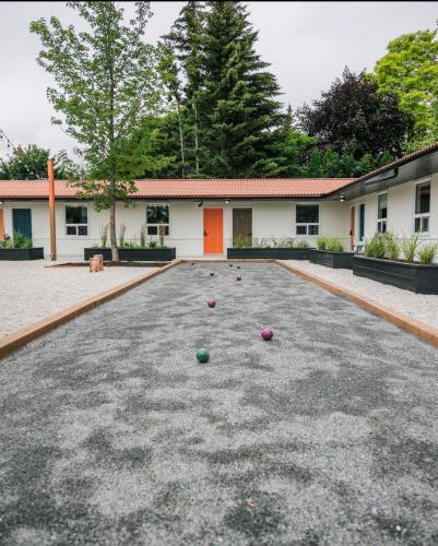 a yard with balls on the ground in front of a building at Penny's Motel in Thornbury