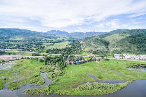 an aerial view of a village on a river and mountains at Alpine Escape in Edwards