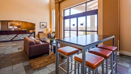 a living room with a table and a couch at Best Western Plus King's Inn and Suites in Kingman