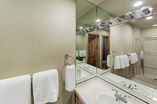 a bathroom with a sink and a large mirror at Vail Golf Club 38 in Vail