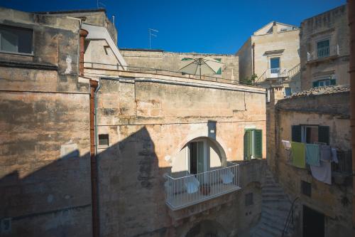 an old building with clothes hanging on a balcony at Donna Lina in Matera