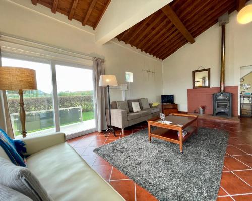 a living room with a couch and a table at Carpe Diem Azores in Mosteiros