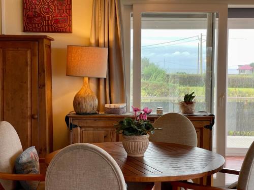 a dining room with a table and chairs and a window at Carpe Diem Azores in Mosteiros