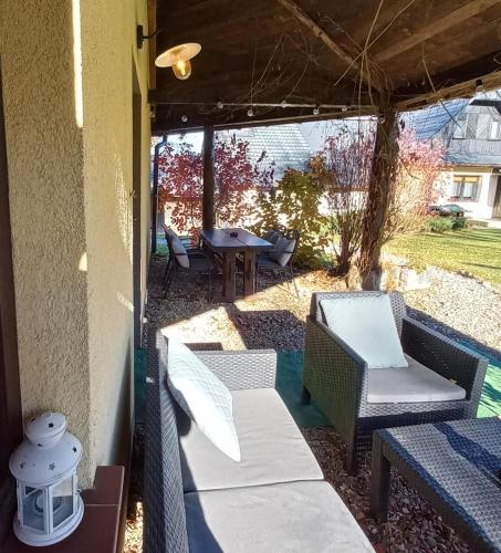a screened in porch with chairs and a table at Pod Małym Jasłem in Cisna