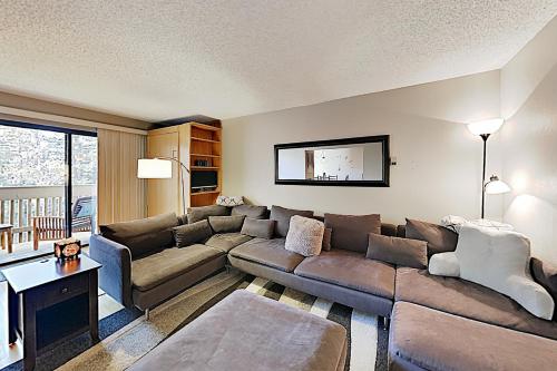 a living room with a couch and a table at Gore Creek Getaway in Vail