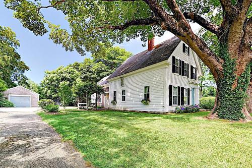 a white house with a tree in the yard at Salty Ridge Station in Orleans