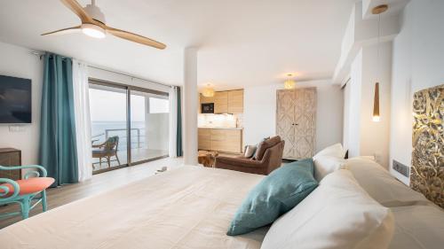 a bedroom with a large bed and a living room at Etti-Paradise Suite La Ballena in Pájara