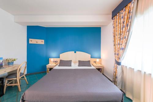 Ένα ή περισσότερα κρεβάτια σε δωμάτιο στο Agave Hotel