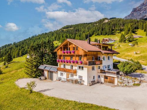 an aerial view of a house on a hill at Garni Baita in San Cassiano