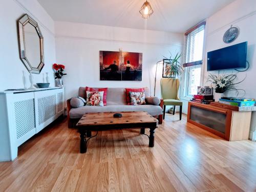 a living room with a couch and a coffee table at Victoriana Apartment - Private Balcony in Stratford-upon-Avon