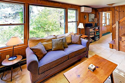 a living room with a couch and a table at Areys Pond Point in Orleans