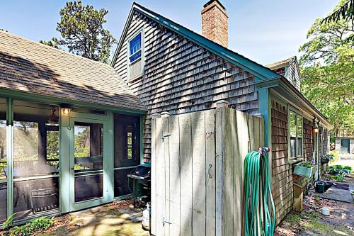 a house with a wooden fence in front of it at Areys Pond Point in Orleans