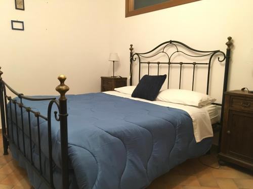 a bedroom with a large bed with a blue blanket at l'eco dei Papi in Viterbo